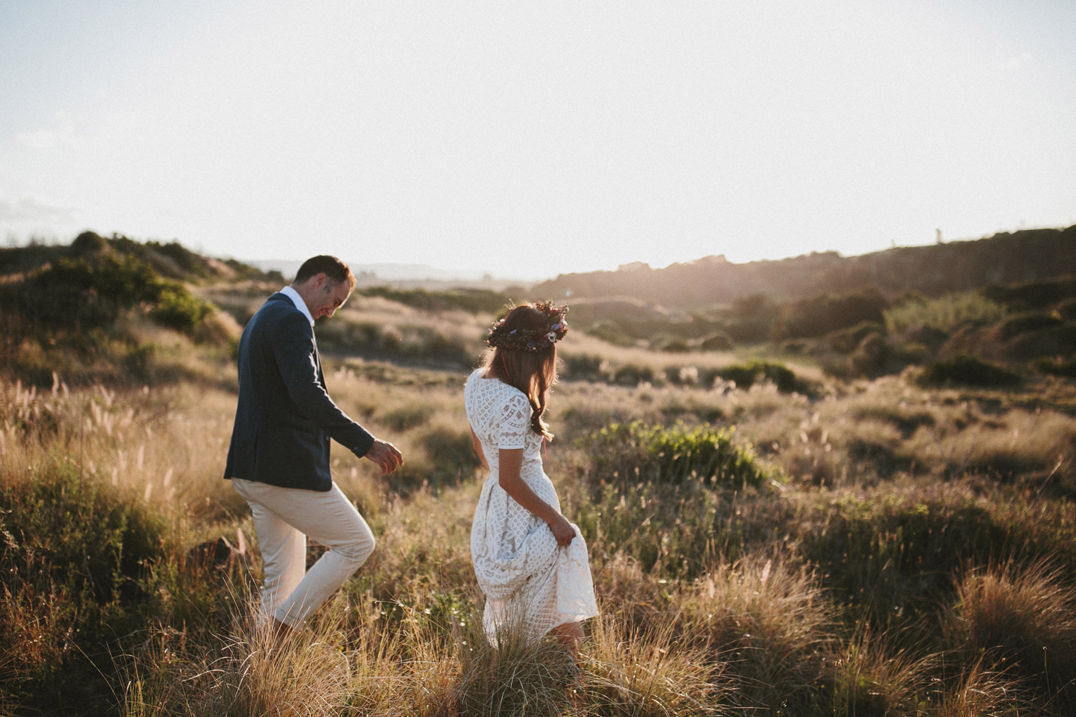 Couple walking at sunset at there Cornwall Coastal Wedding 