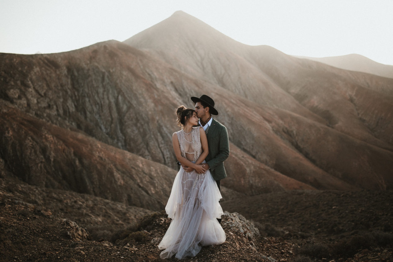 Editorial-style couple portrait against modern architecture