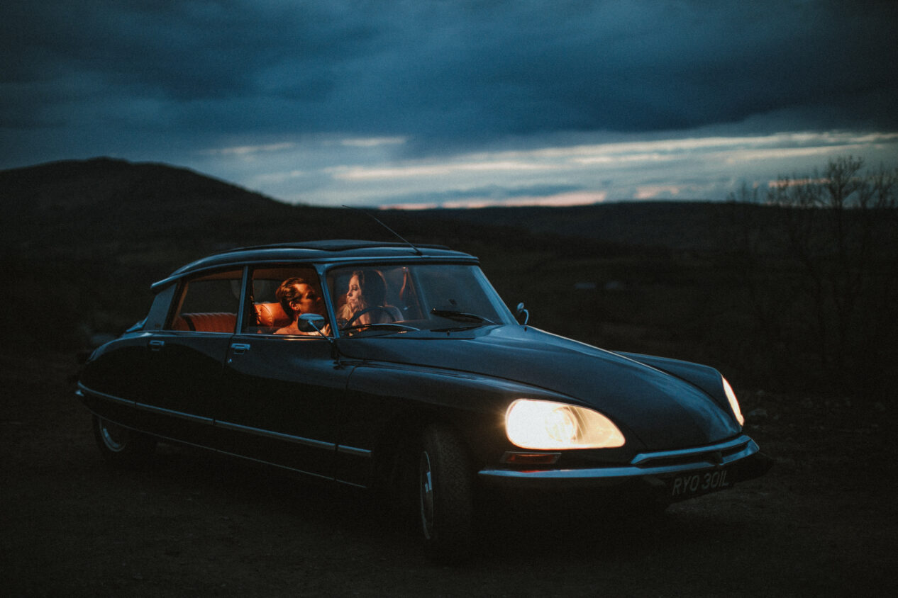 Bride and groom walking in golden fields — Cotswolds wedding photographer capturing cinematic moments